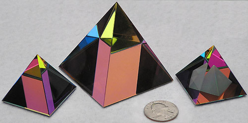 Sparkly and Colorful Crystal Pyramids to Sit on a Shelf and Entertain You As You Pass! From Left to Right Sizes are 40mm, 60mm, and 40mm, all with Peacock Color Coating. Pyramid at Right has an Additional Frosted Pyramid Carved Inside.