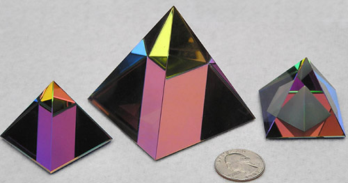 Sparkly and Colorful Crystal Pyramids. From Left to Right Sizes are 40mm, 60mm, and 40mm, all with Peacock Color Coating. Pyramid at Right has an Additional Frosted Pyramid Carved Inside.